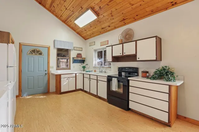 a spacious bedroom with a bed and a chandelier