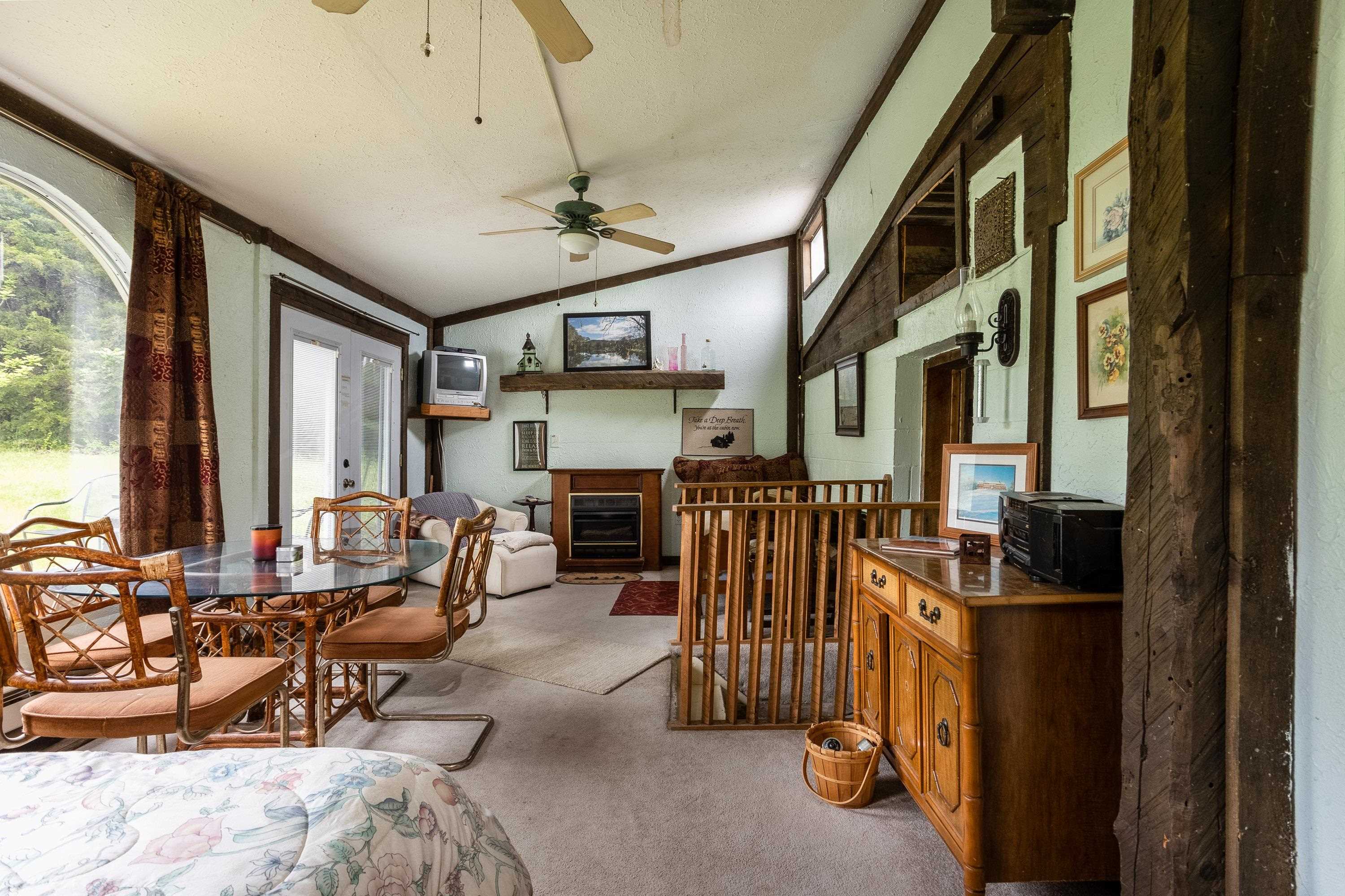 9881 Fort Valley Road Fort Valley, VA 22652 - Photo 21 of 75 a view of a livingroom with furniture and a ceiling fan
