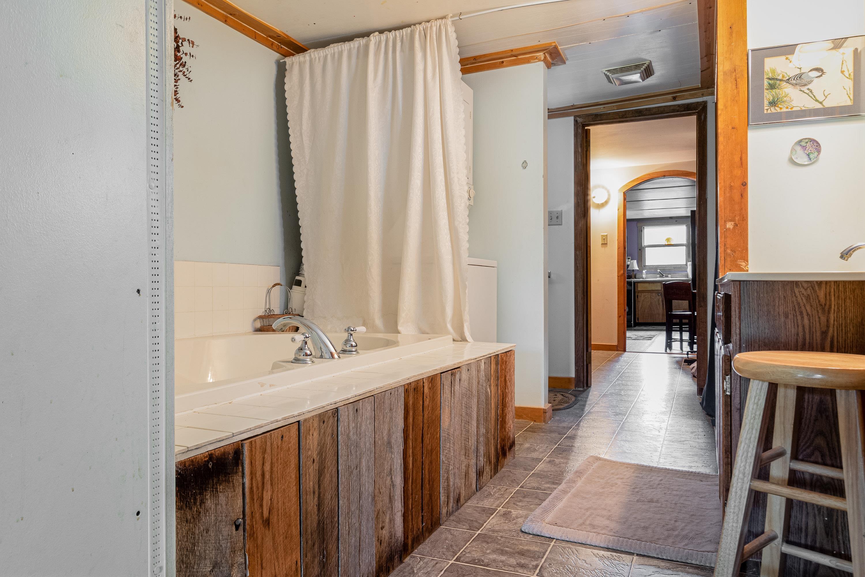 9881 Fort Valley Road Fort Valley, VA 22652 - Photo 22 of 75 a bathroom with a sink a mirror and a shower