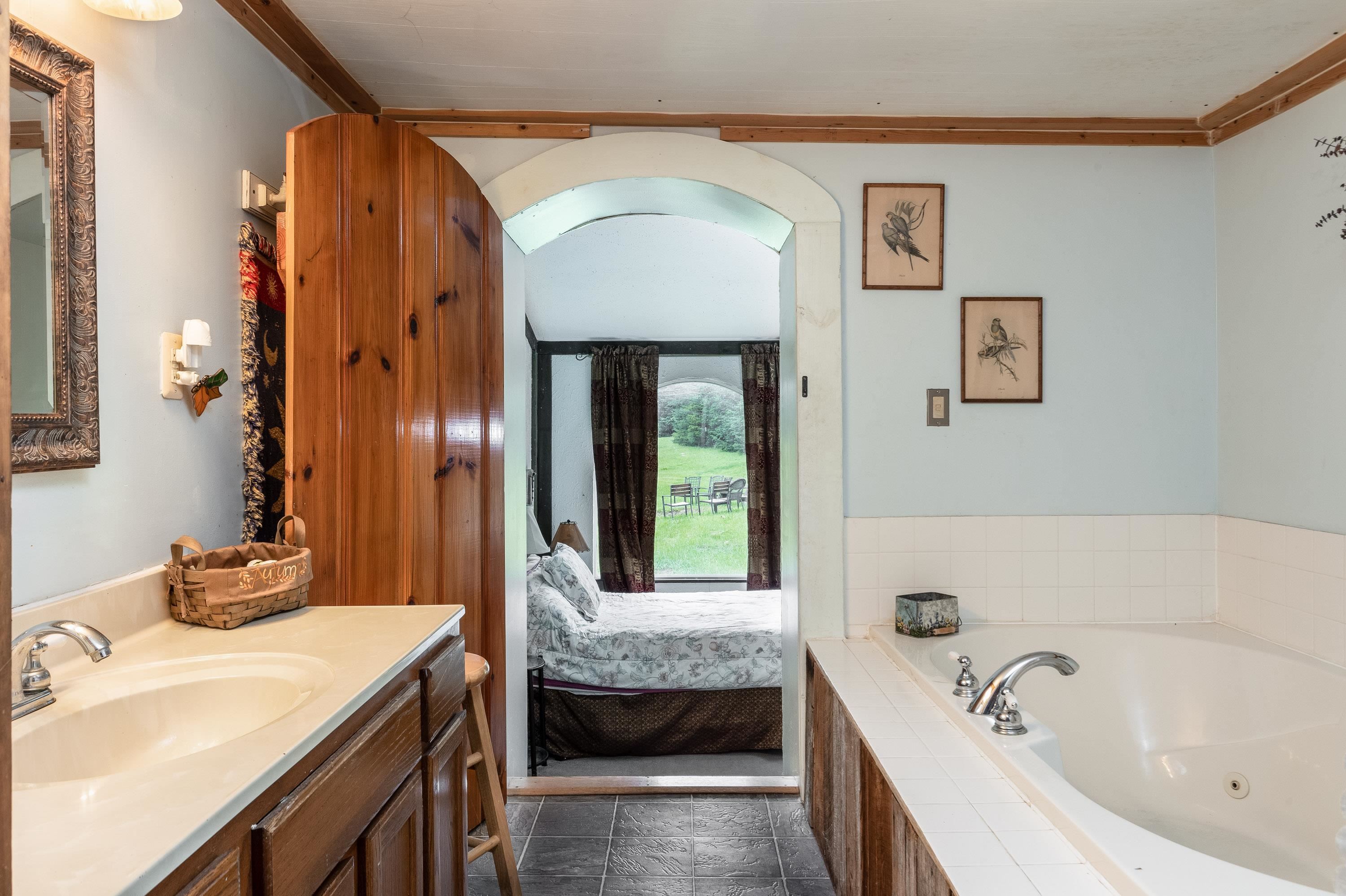 9881 Fort Valley Road Fort Valley, VA 22652 - Photo 23 of 75 a bathroom with a tub sink and mirror