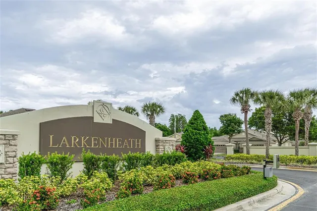 an aerial view of a house with a yard and trees