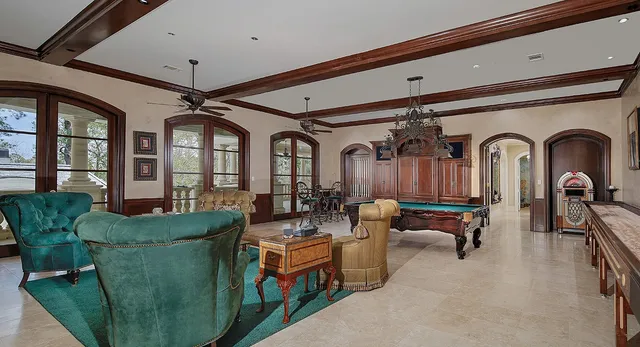 a living room with furniture a flat screen tv and a large window