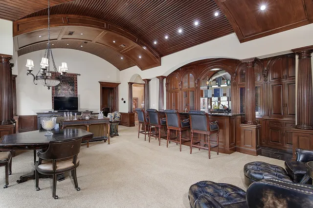 a living room with furniture a fireplace and a chandelier