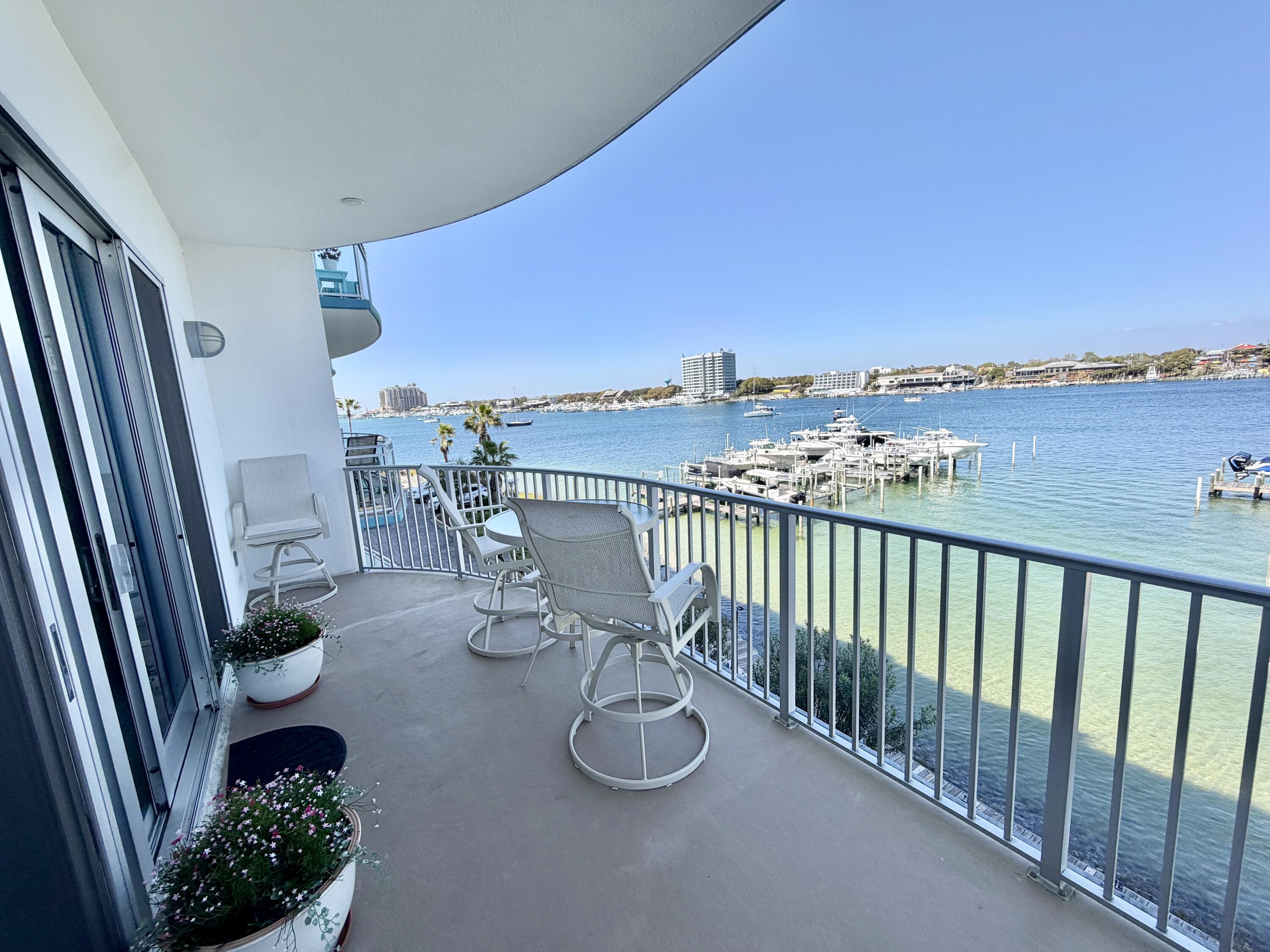 a balcony with dining table and chairs