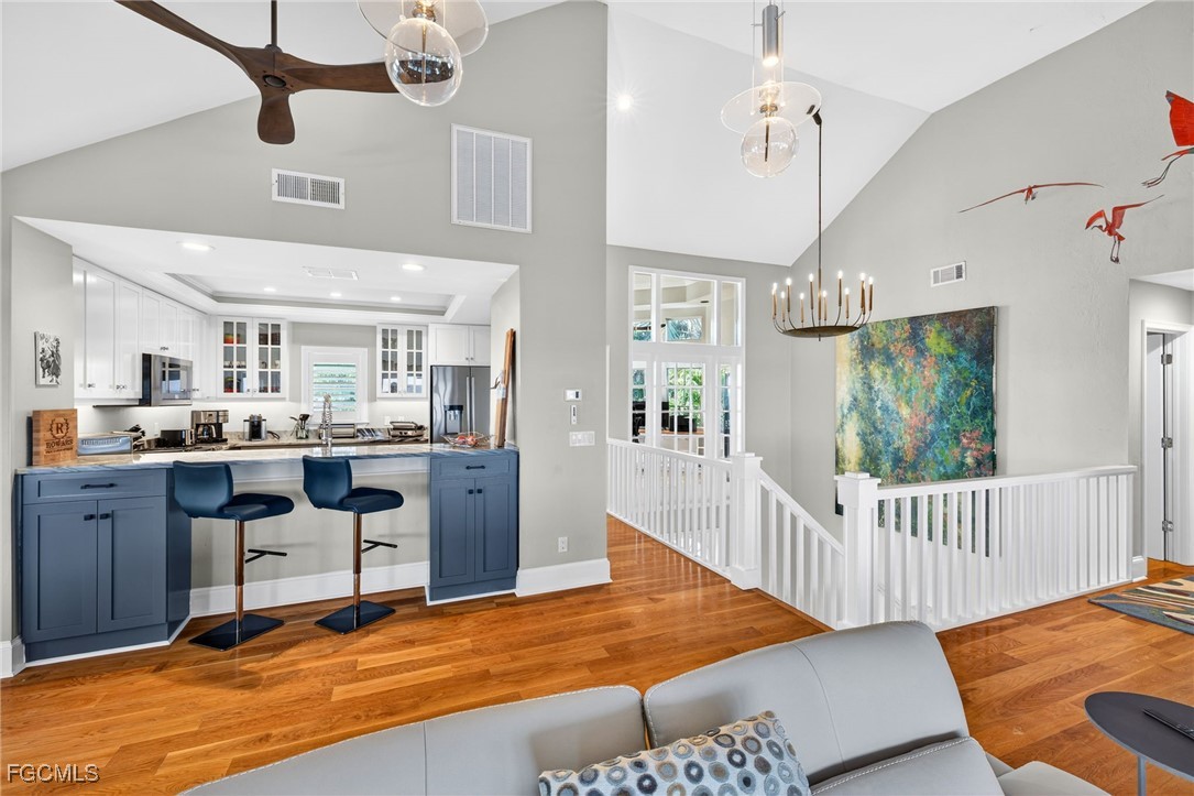 323 Useppa Island Bokeelia, FL 33922 - Photo 13 of 36 a living room with kitchen island granite countertop furniture wooden floor and a rug