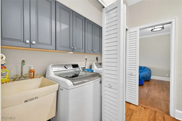 a kitchen with a refrigerator sink and cabinets