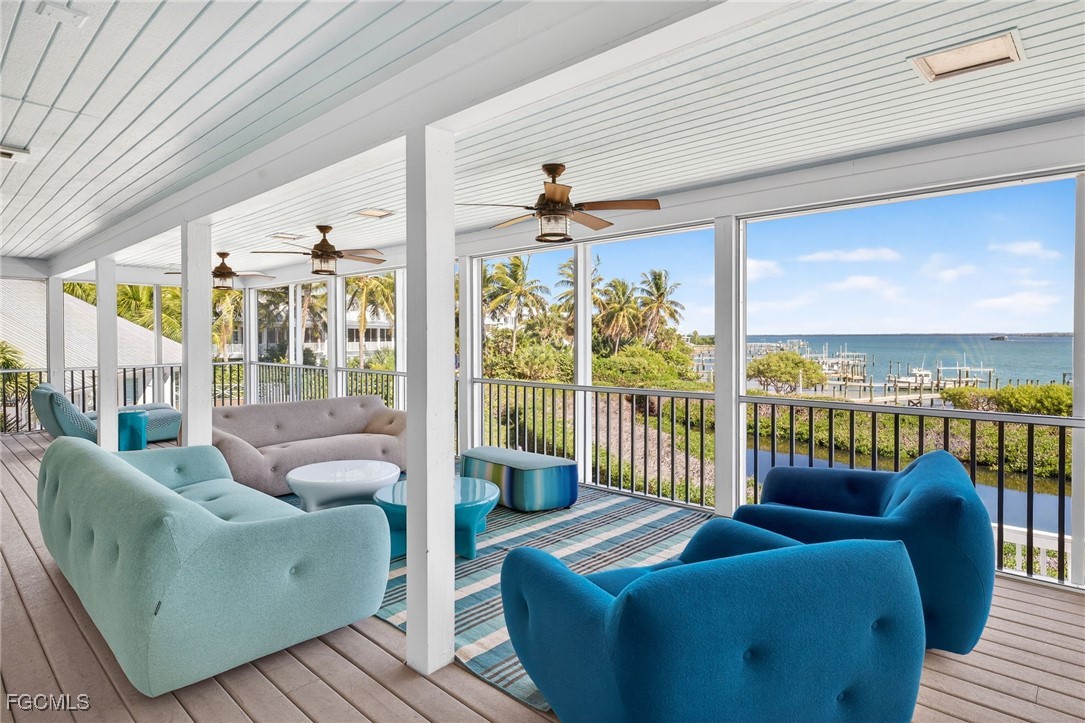 323 Useppa Island Bokeelia, FL 33922 - Photo 31 of 36 a living room with furniture floor to ceiling window and wooden floor