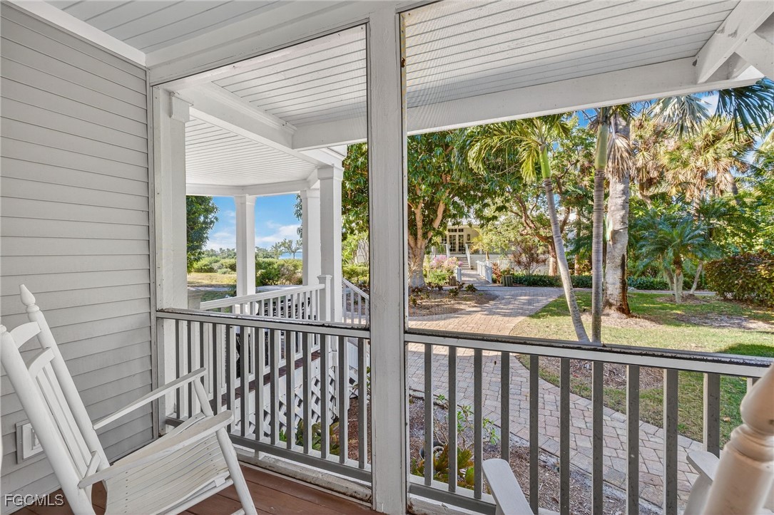 323 Useppa Island Bokeelia, FL 33922 - Photo 33 of 36 a view of a balcony with floor to ceiling windows with wooden floor