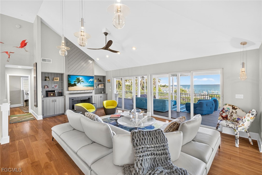 323 Useppa Island Bokeelia, FL 33922 - Photo 5 of 36 a living room with furniture kitchen view and a large window