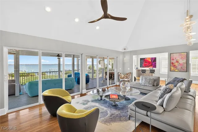 a living room with furniture and a floor to ceiling window
