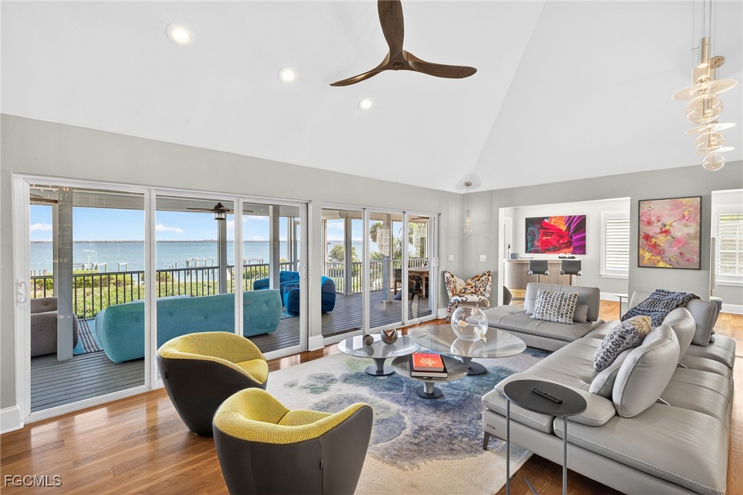 323 Useppa Island Bokeelia, FL 33922 - Photo 6 of 36 a living room with furniture and a floor to ceiling window