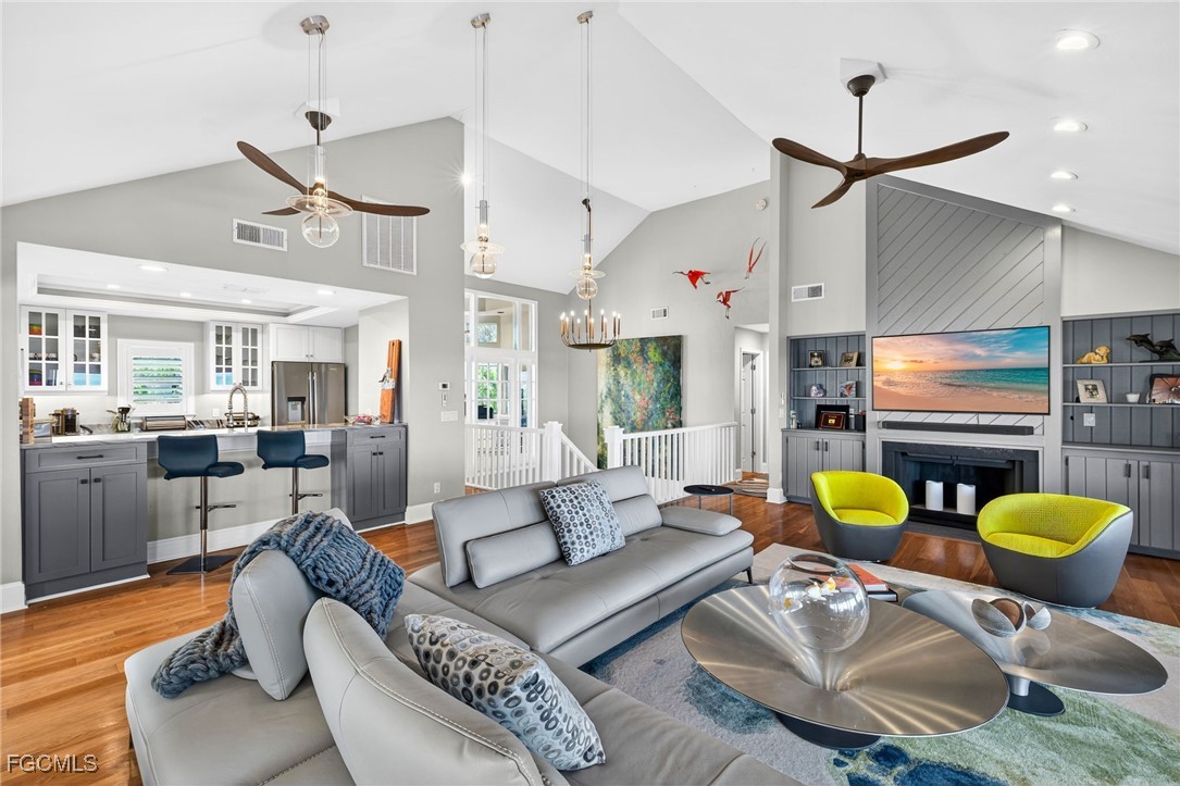 323 Useppa Island Bokeelia, FL 33922 - Photo 7 of 36 a living room with furniture kitchen view and a chandelier