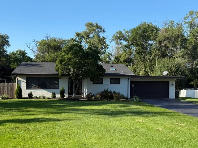 a front view of house with yard and green space