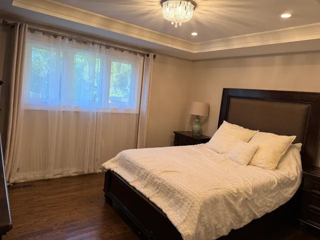 a bed sitting in a bedroom next to a bathroom