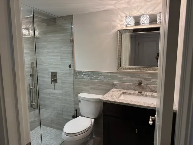a bathroom with a sink toilet and mirror