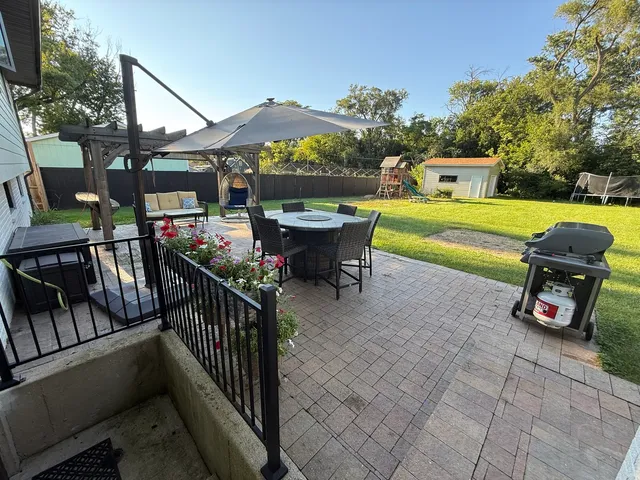 a view of a patio with couches table and chairs and potted plants