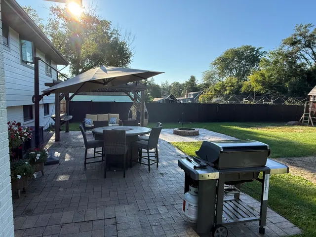 a view of a swimming pool with outdoor seating and plants