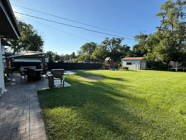 a view of a house with backyard porch and sitting area