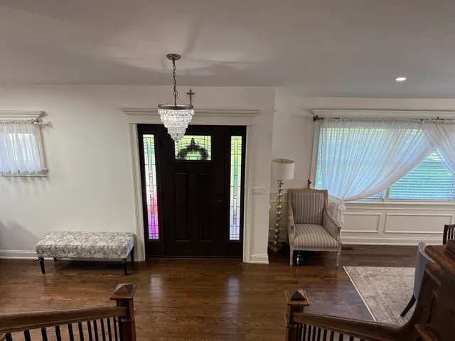 a living room with furniture and a chandelier