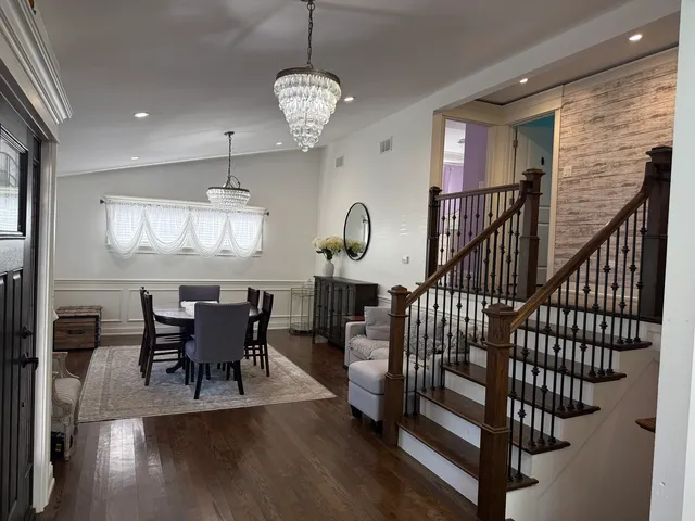 a view of a dining room and hall with wooden floor