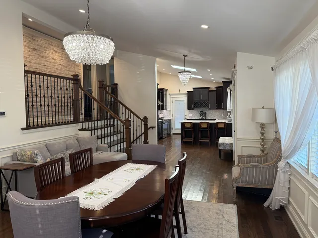 a dining room with furniture and wooden floor
