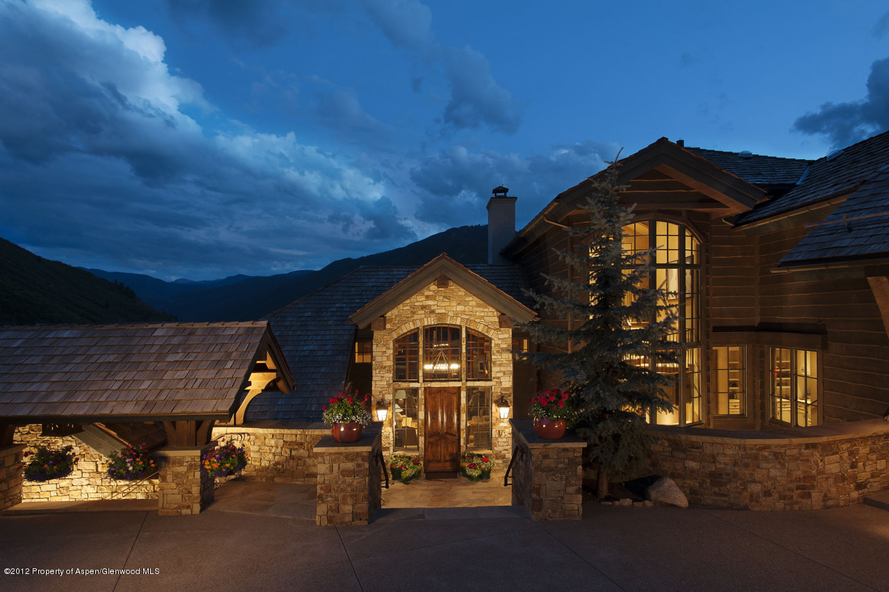 639 Hunter Creek Road Aspen, CO 81611 - Photo 11 of 13 a view of a brick house with a small yard and large tree