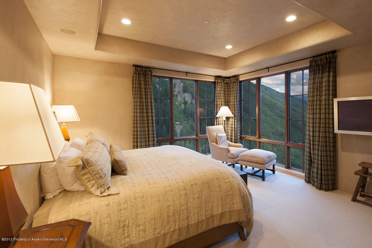 639 Hunter Creek Road Aspen, CO 81611 - Photo 12 of 13 a bed room with a bed and a large window