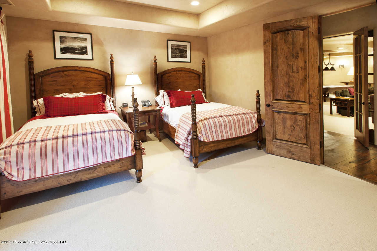 639 Hunter Creek Road Aspen, CO 81611 - Photo 13 of 13 a bedroom with a bed and wooden floor