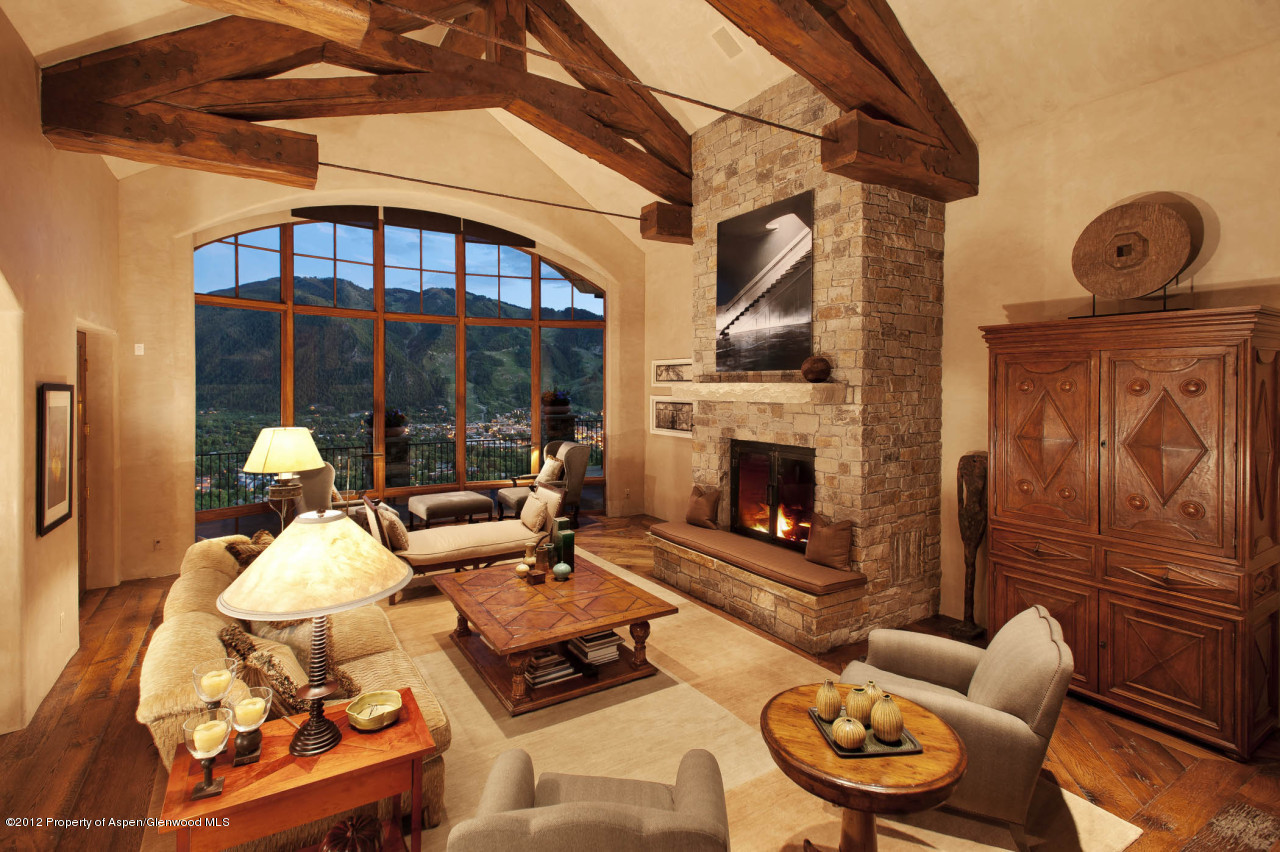 639 Hunter Creek Road Aspen, CO 81611 - Photo 2 of 13 a living room with furniture a fireplace and a floor to ceiling window