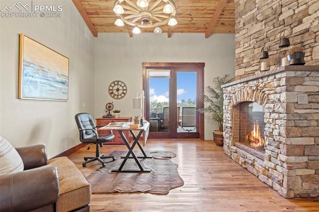 7115 Wildridge Road Colorado Springs, CO 80908 - Photo 27 of 49 Office with double sided fireplace and walk out