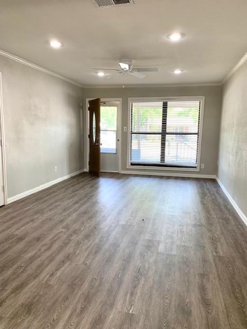768 Pine Street Hurst, TX 76053 - Photo 2 of 11 Unfurnished room with crown molding, ceiling fan, dark wood-type flooring, a textured wall, and recessed lighting
