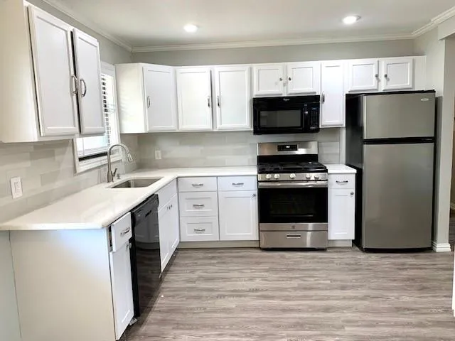 a kitchen with a stove sink and a refrigerator