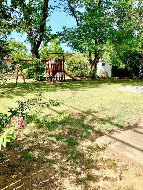 768 Pine Street Hurst, TX 76053 - Photo 10 of 11 View of grassy yard with a playground