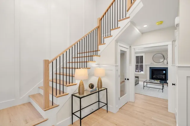 a view of entryway and hall with wooden floor