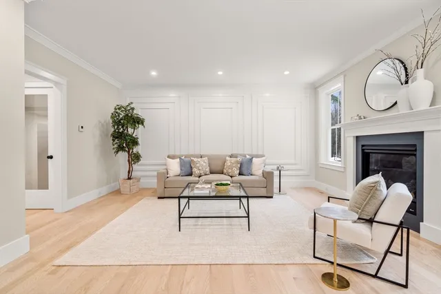 a living room with furniture a fireplace and a rug