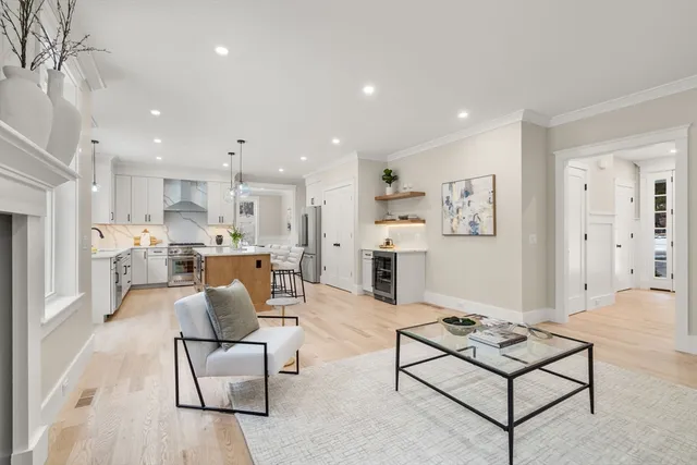 a living room with furniture and kitchen view