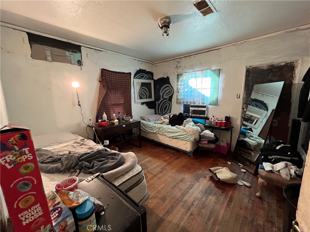 45639 King Street Indio, CA 92201 - Photo 14 of 28 a bedroom with furniture and a wooden floor