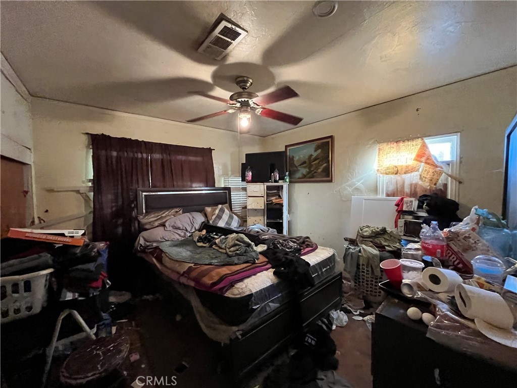 45639 King Street Indio, CA 92201 - Photo 15 of 28 a bedroom with furniture a chandelier a rug and a window