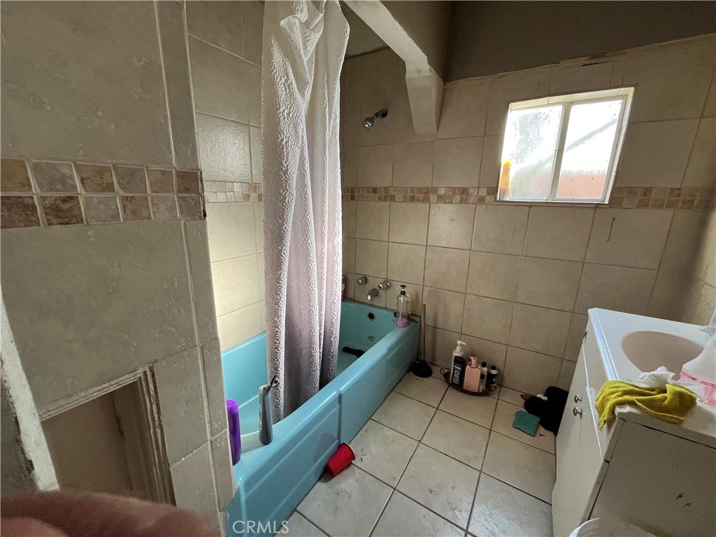 45639 King Street Indio, CA 92201 - Photo 16 of 28 a bathroom with a sink and glass door shower