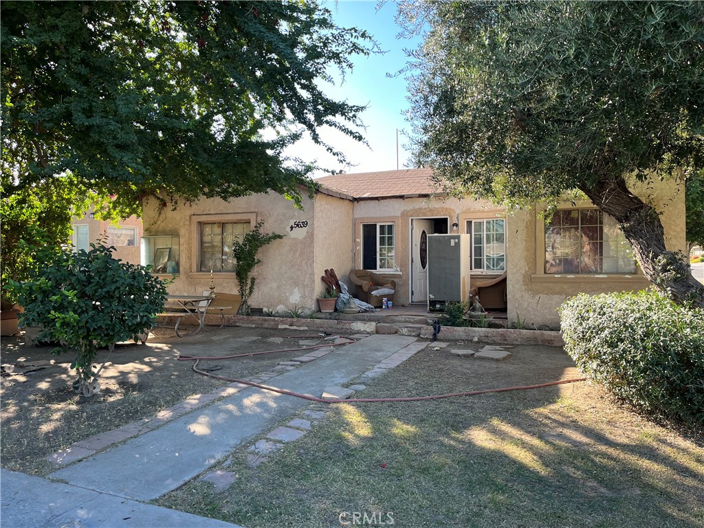 45639 King Street Indio, CA 92201 - Photo 2 of 28 a view of a white house with a tree in front of it