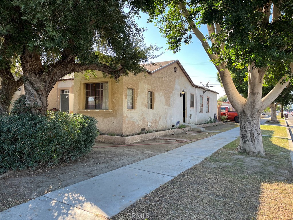 45639 King Street Indio, CA 92201 - Photo 3 of 28 a front view of a house with yard and tree