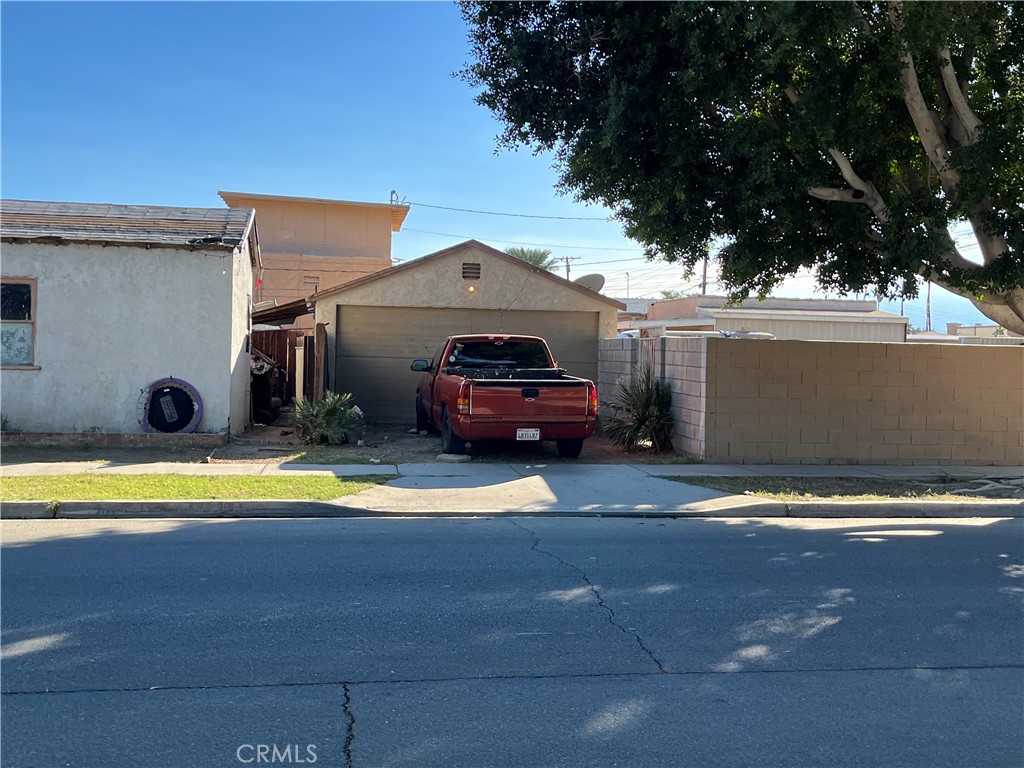 45639 King Street Indio, CA 92201 - Photo 5 of 28 a front view of a house with a yard