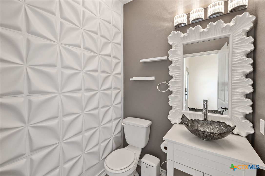 10113 Copper Ridge Cove Austin, TX 78747 - Photo 5 of 32 a bathroom with a sink a toilet and shower curtain