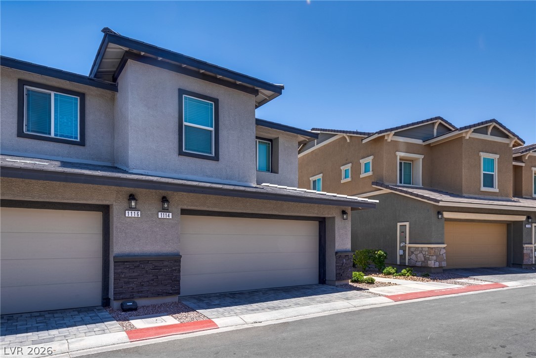 1114 Scarlet Sparrow Street Henderson, NV 89011 - Photo 4 of 25 Contemporary facades and integrated garages offer practical living solutions with modern flair.