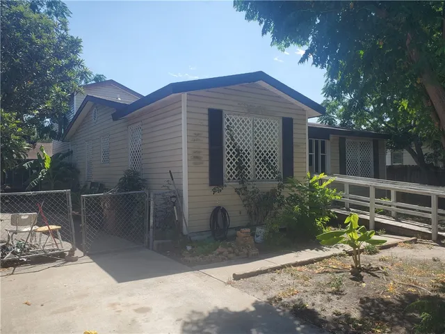 a backyard of a house with plants and trees