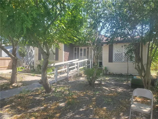 a backyard of a house with table and chairs