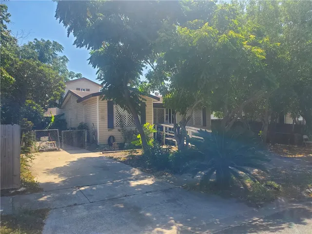 a backyard of a house with table and chairs