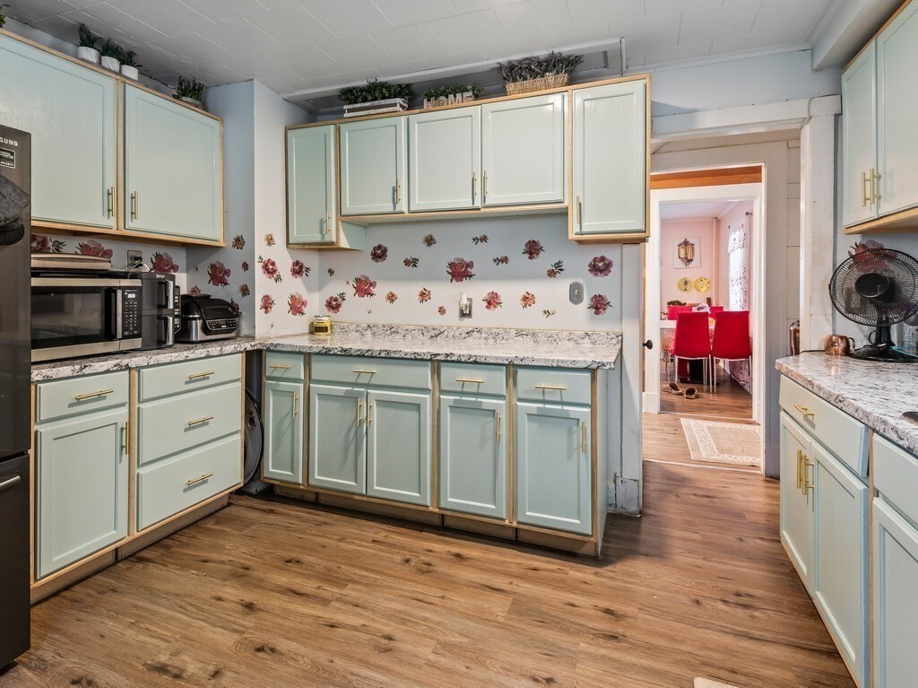 28 Maple Street Southbridge, MA 01550 - Photo 11 of 36 a kitchen with stainless steel appliances white cabinets and a stove top oven
