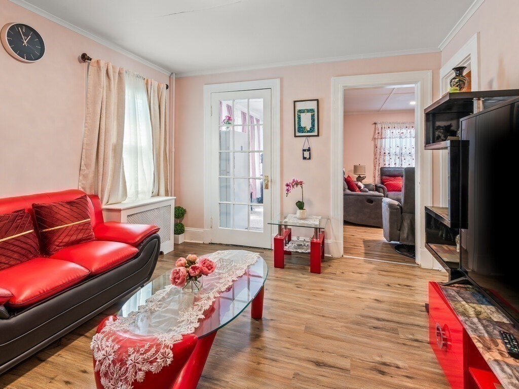 28 Maple Street Southbridge, MA 01550 - Photo 15 of 36 a living room with furniture a flat screen tv and a refrigerator