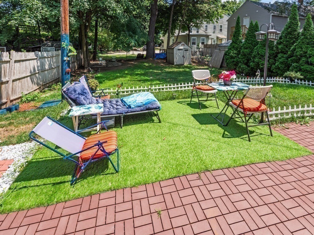 28 Maple Street Southbridge, MA 01550 - Photo 17 of 36 a wooden bench sitting in the grass near a garden